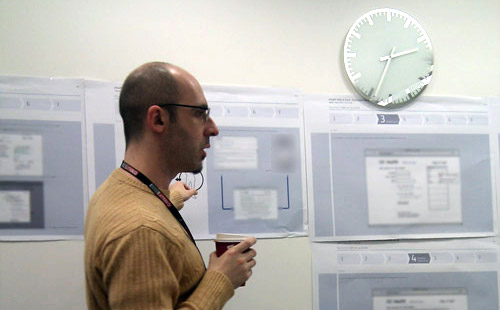 Javier Gala conducting a workshop, pointing at a diagram hanging on the wall